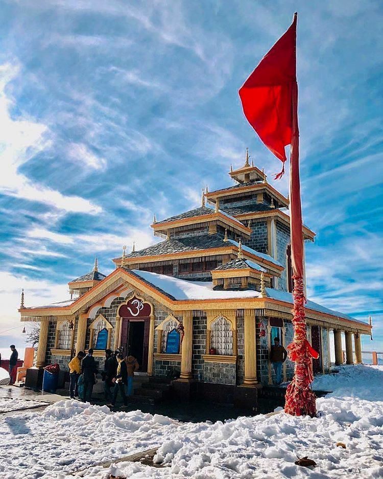 A majestic Himalayan temple standing gracefully amidst pristine snow, symbolizing the divine serenity and spiritual power of the sacred Char Dham pilgrimage.